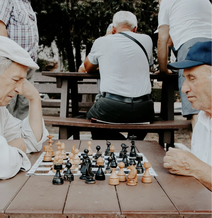 Two elderly people playing chess