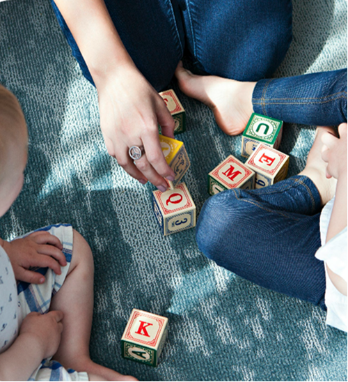 People playing with letter and number cubes