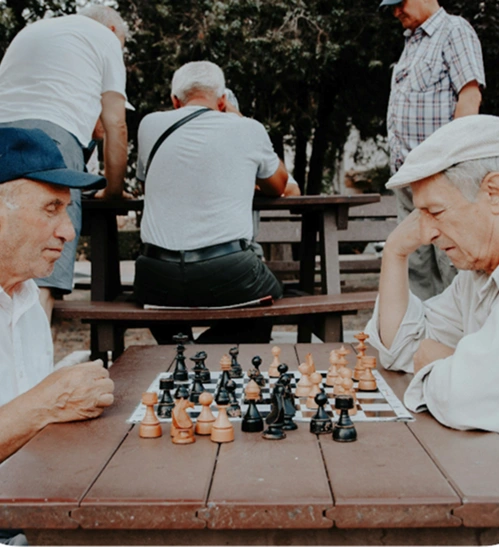 Two elderly people playing chess