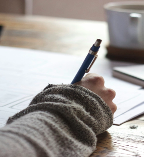 Person writing on a piece of paper