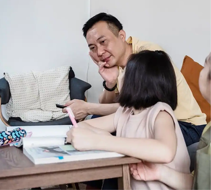 Father watching a girl write