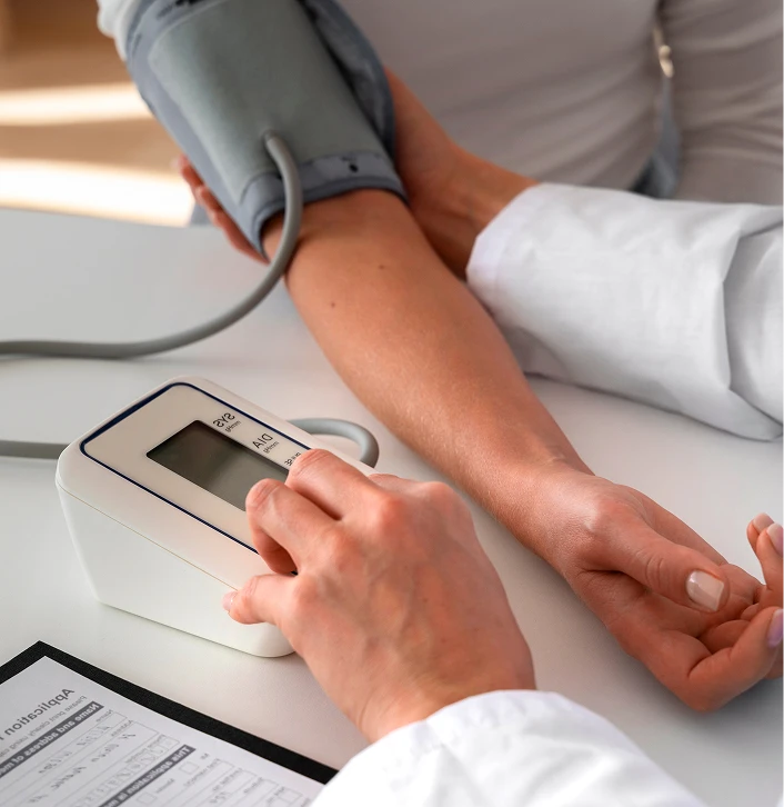 Doctor taking a woman's blood pressure