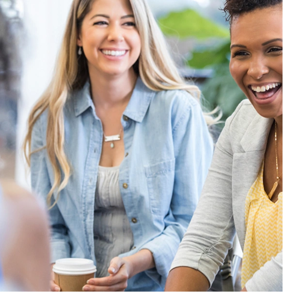 Two women laughing in conversation