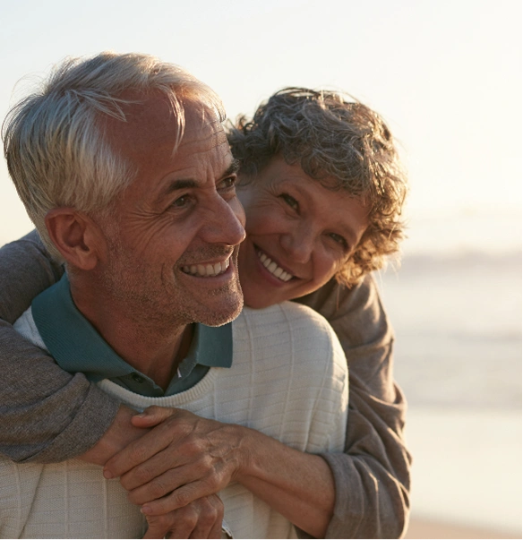 Two older people hugging each other