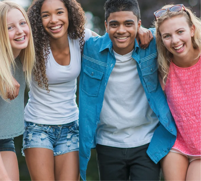 Four friends hugging each other